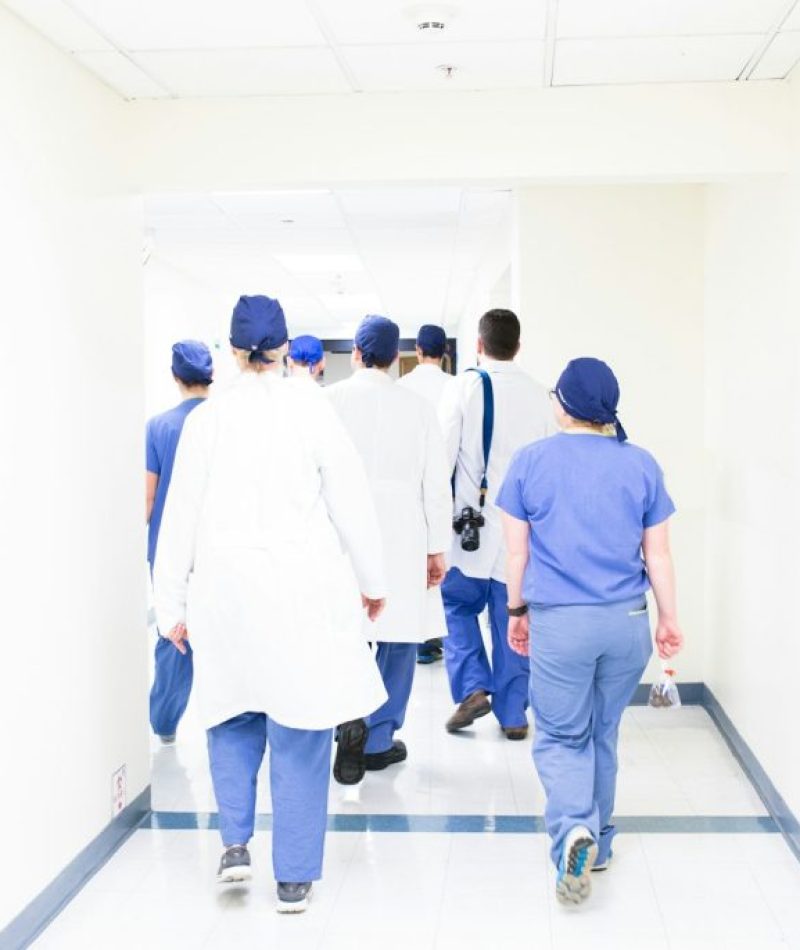 group of doctors walking on hospital hallway